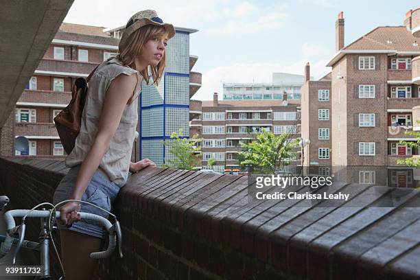 woman looking over balcony - hackney london stock pictures, royalty-free photos & images