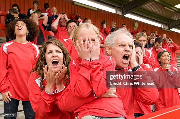 despairing fans at football match - grandfather face stock-fotos und bilder