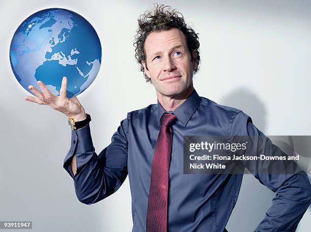 business man holds up globe - man holding paper stock pictures, royalty-free photos & images