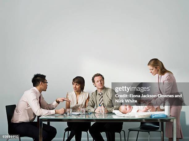 changing baby's nappy in a meeting - bridge building glass stock pictures, royalty-free photos & images