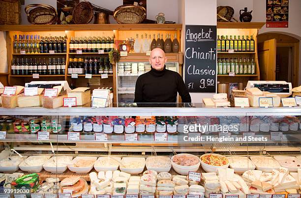 cheese, wine store owner in shop - deli counter stockfoto's en -beelden