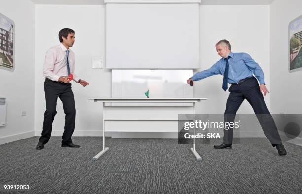 business men playing table tennis - tafeltennis stockfoto's en -beelden