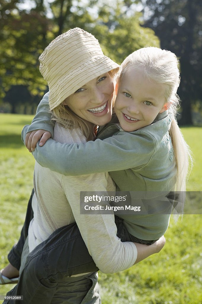 A young girl and her mother in the park