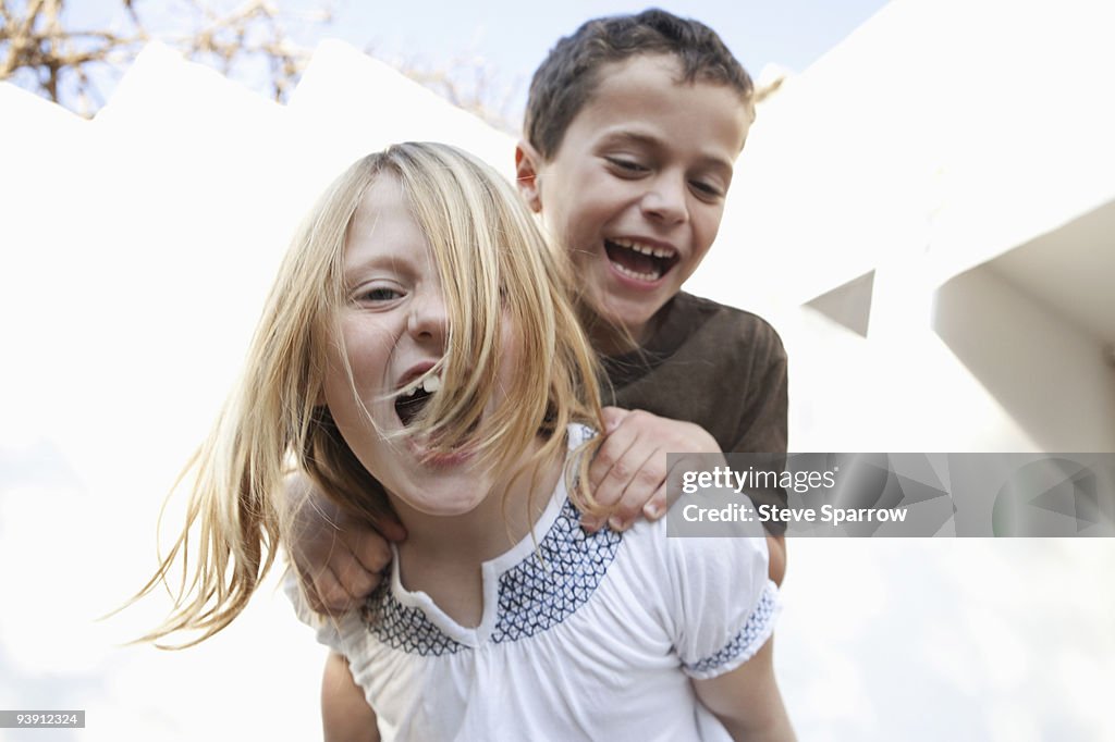 Boy and girl smiling at camera