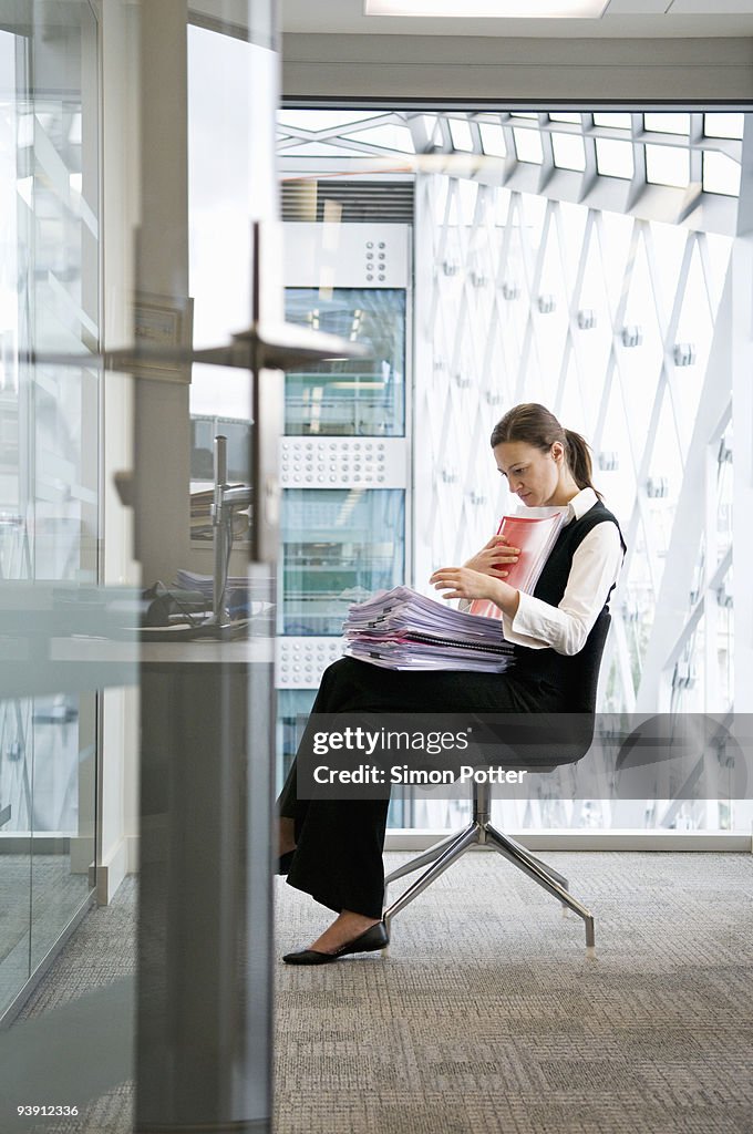 A business woman looking through files