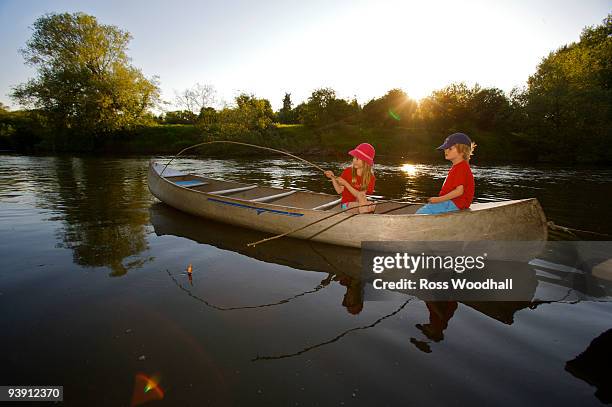 young girl and boy fishing. - ross woodhall stock pictures, royalty-free photos & images