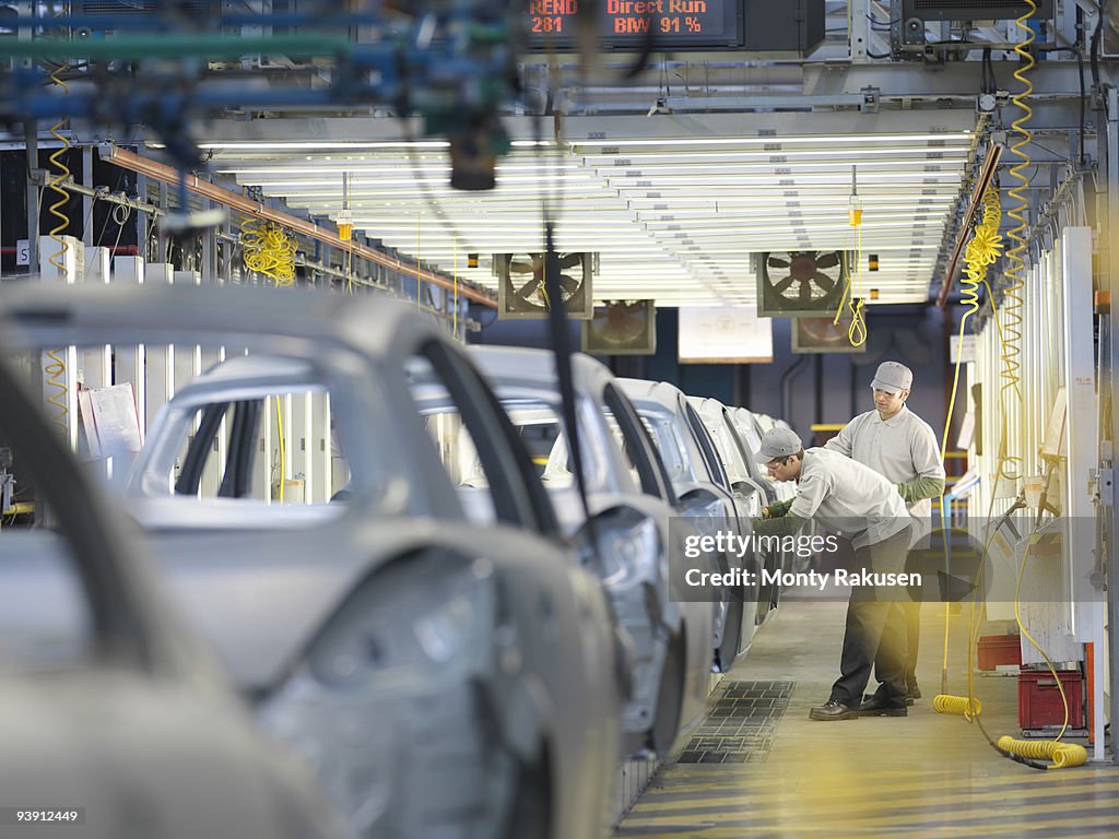 Car Plant Workers On Production Line