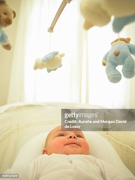 baby looking at mobile - david de lossy sleep stock pictures, royalty-free photos & images