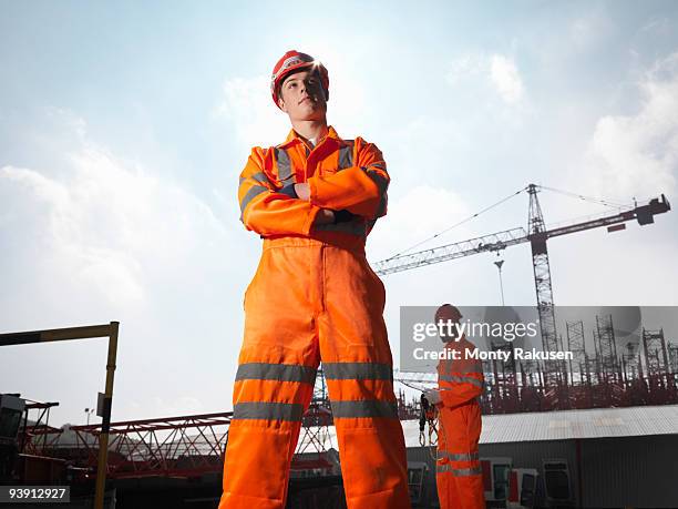 workers and cranes - white jumpsuit stock pictures, royalty-free photos & images