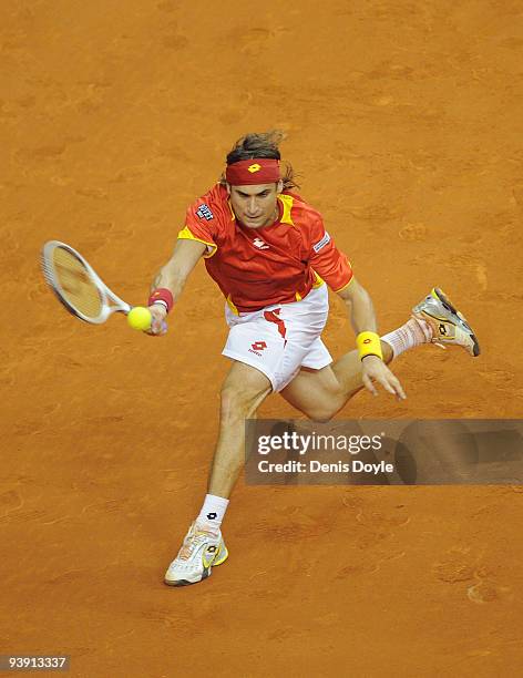 David Ferrer of Spain returns a shot to Radek Stepanek of Czech Republic during the second match of the Davis Cup final at the Palau Sant Jordi...