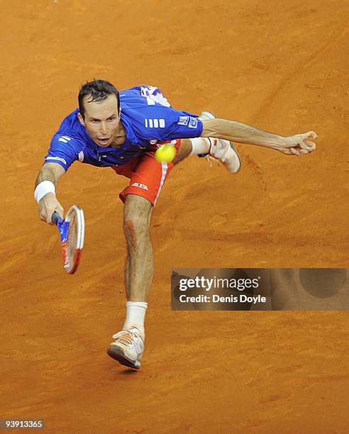 Radek Stepanek of Czech Republic returns a shot to David Ferrer of Spain during the second match of the Davis Cup final at the Palau Sant Jordi...