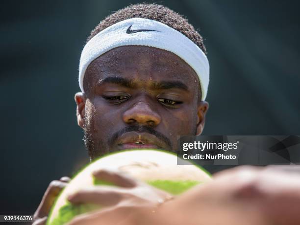 Frances Tiafoe, from the USA, signs a big tennis ball for his fans after defeating Tomas Berdych, from the Czech Republic, at the Miami Open in Key...