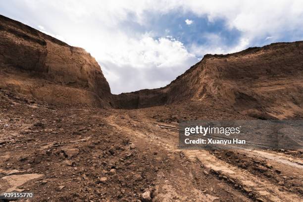 dirt road passing through a desert, auto advertising background - rocky terrains stock pictures, royalty-free photos & images