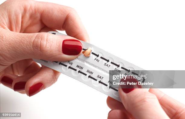 teenager taking contraceptive pill from blister pack - birth control stockfoto's en -beelden