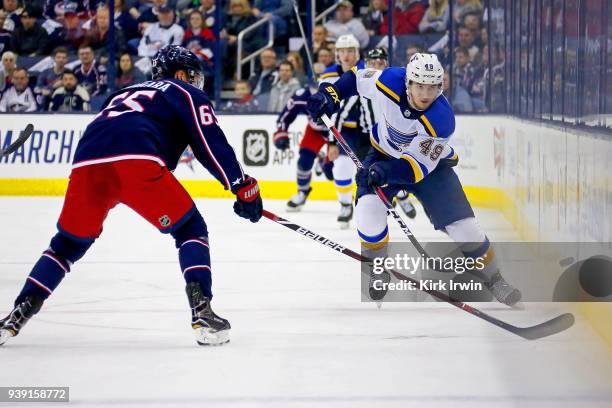 Ivan Barbashev of the St. Louis Blues flips the puck past Markus Nutivaara of the Columbus Blue Jackets during the game on March 24, 2018 at...