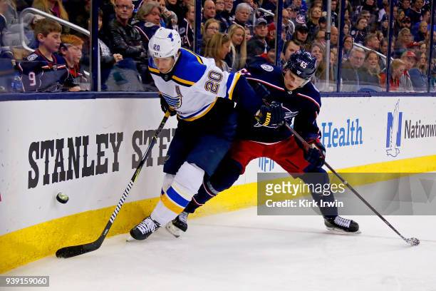 Alexander Steen of the St. Louis Blues and Markus Nutivaara of the Columbus Blue Jackets battle for control of the puck during the game on March 24,...