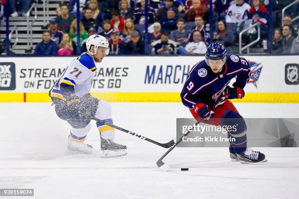 Artemi Panarin of the Columbus Blue Jackets skates the puck away from Vladimir Sobotka of the St. Louis Blues during the game on March 24, 2018 at...