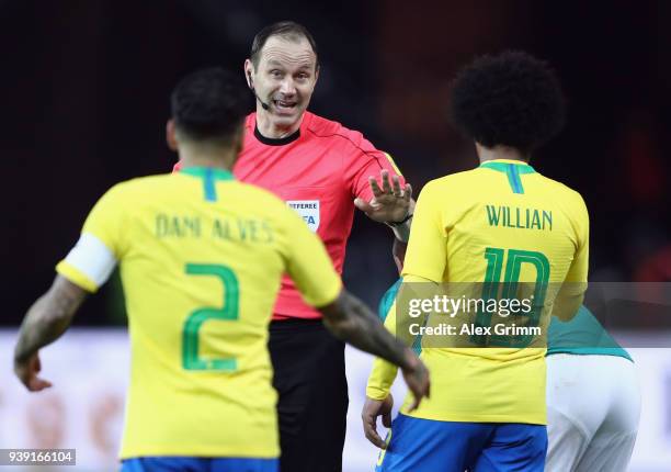 Referee Jonas Eriksson talks to Dani Alves and Willian of Brazil during the international friendly match between Germany and Brazil at Olympiastadion...