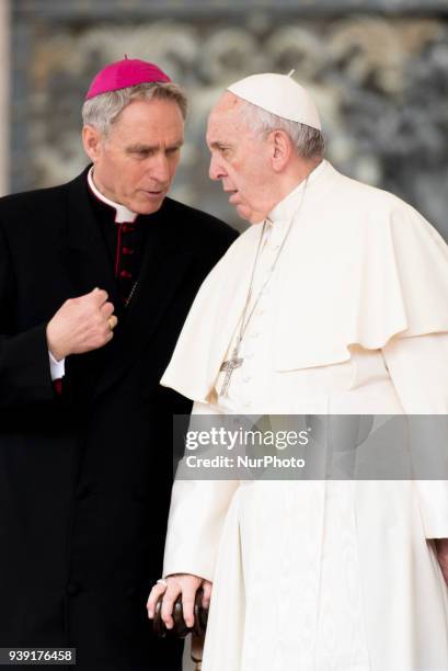 Pope Francis talks with Archibishop Georg Gänswein when his arrives in St. Peter's Square at the Vatican before his weekly general audience,...