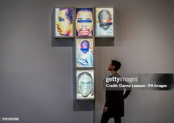 Kerry Chase&Ecirc;views a work titiled Self-Portrait 'Black Men Public Enemy'' by artist Donald Rodney,that forms part of the In My Shoes exhibition...