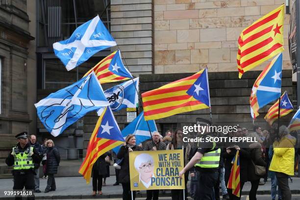 Police stand by as supporters wave Catalan pro-independence Estelada flags and Scottish Saltire flags outside the court where former Catalan minister...