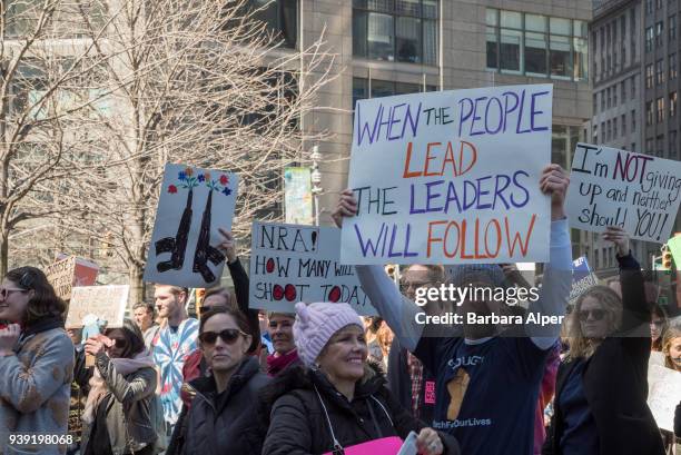 View of demonstrators, many with signs, as they participate in the March For Our Lives rally against gun violence, near Columbus Circle, New York,...