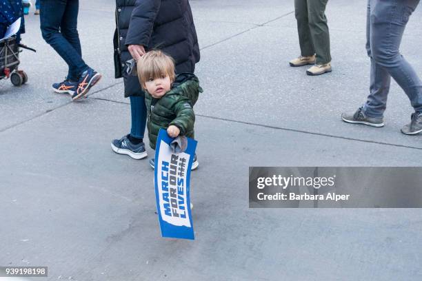 View of young demonstrators, with a sign that reads 'March For Our Lives,' at a rally against gun violence, near Columbus Circle, New York, New York,...