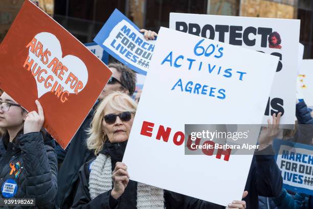 View of demonstrators, many with signs, as they participate in the March For Our Lives rally against gun violence, near Columbus Circle, New York,...