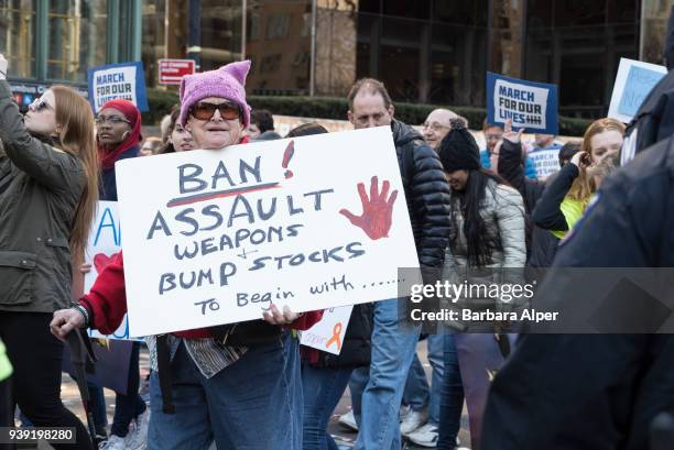 Portrait of elderly demonstrator as she holds a sign that reads 'Ban Assault Weapons and Bump Stocks to Begin With…,' during the March For Our Lives...