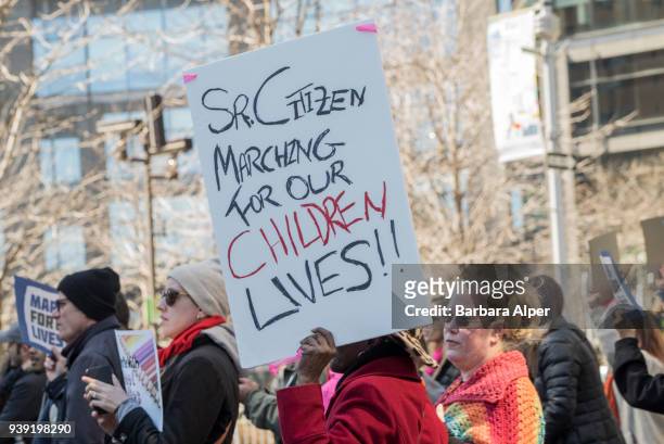 View of demonstrator as she holds up a sign that reads 'Sr Citizen Marching for Our Children [sic] Lives,' during the March For Our Lives rally...