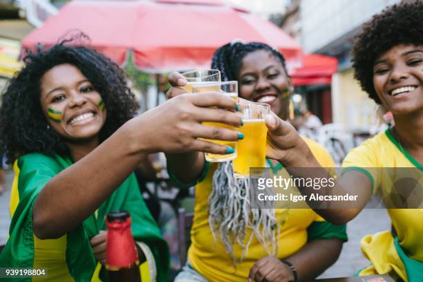 toast to celebrate brazil's victory - moving down to seated position stock pictures, royalty-free photos & images