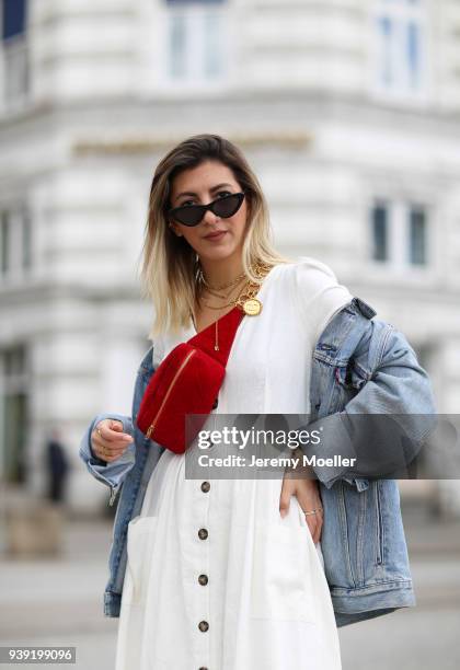 Aylin Koenig wearing a Levis Jeans jacket, Chanel belt bag, Cartier jewelry, Le Specs sunglasses, Zara dress on March 27, 2018 in Hamburg, Germany. .