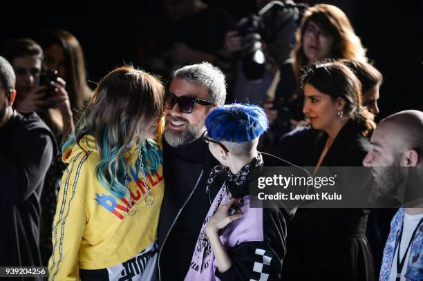 Fashion designers Deniz Berdan, Hakan Akkaya and Begum Berdan attend the DB Berdan show during Mercedes Benz Fashion Week Istanbul at Zorlu Center on...