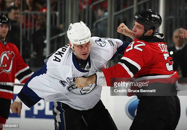 Zenon Konopka of the Tampa Bay Lightning and Matthew Corrente of the New Jersey Devils exchange punches at the Prudential Center on December 4, 2009...