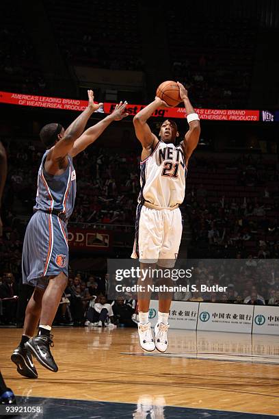 Bobby Simmons of the New Jersey Nets shoots against Acie Law of the Charlotte Bobcats on December 4, 2009 at the IZOD Center in East Rutherford, New...