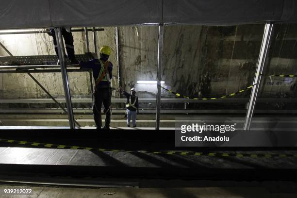 Construction workers complete the Mass Rapid Transit development project at Dukuh Atas, in Jakarta, Indonesia, on March 28, 2018. In the first phase...