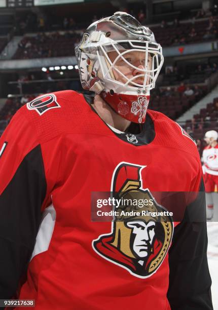Mike Condon of the Ottawa Senators looks on during warmup prior to a game against the Carolina Hurricanes at Canadian Tire Centre on March 24, 2018...