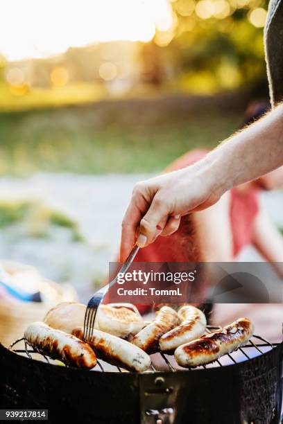 sausages being cooked on barbecue - summer sausage stock pictures, royalty-free photos & images