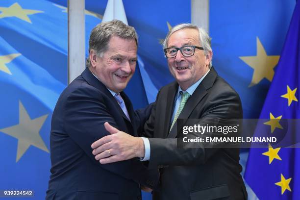 Finland's President Sauli Niinisto is welcomed by European Commission President Jean-Claude Juncker at the European Commission in Brussels on March...