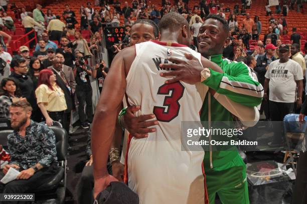 Player, Antonio Brown and Dwyane Wade of the Miami Heat hug after the game against the Cleveland Cavaliers on March 27, 2018 at American Airlines...