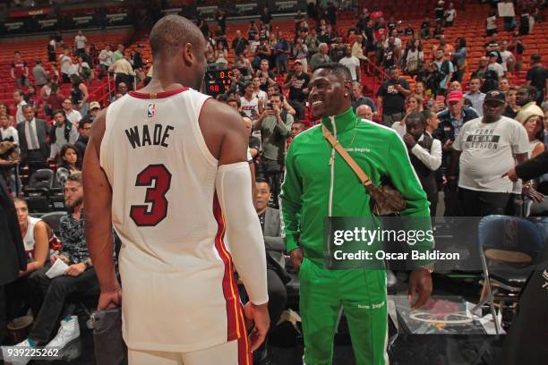 Player, Antonio Brown and Dwyane Wade of the Miami Heat talk after the game against the Cleveland Cavaliers on March 27, 2018 at American Airlines...