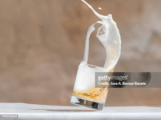 impact of a glass  with beer that falls down on the soil. - beer splash stock pictures, royalty-free photos & images