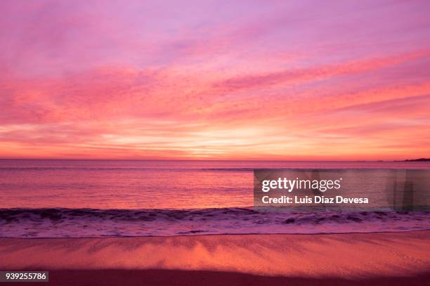 sunset in the lanzada beach - red sky stock-fotos und bilder