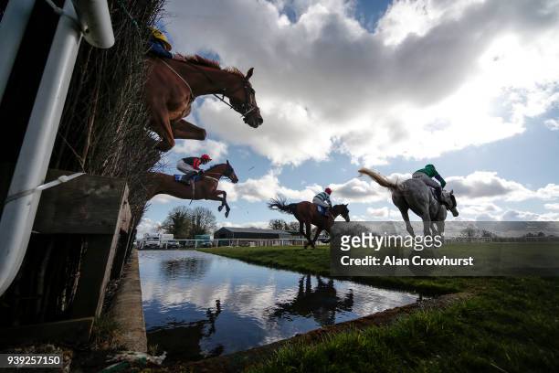 Harry Cobden riding Cucklington clear the water jump on their way to winning The Smarkets Handicap Steeple Chase at Wincanton Racecourse on March 28,...