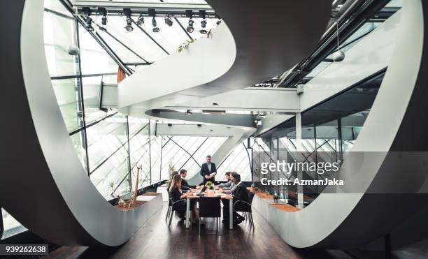 businessman presenting the new plan to his colleagues - cool attitude stock pictures, royalty-free photos & images