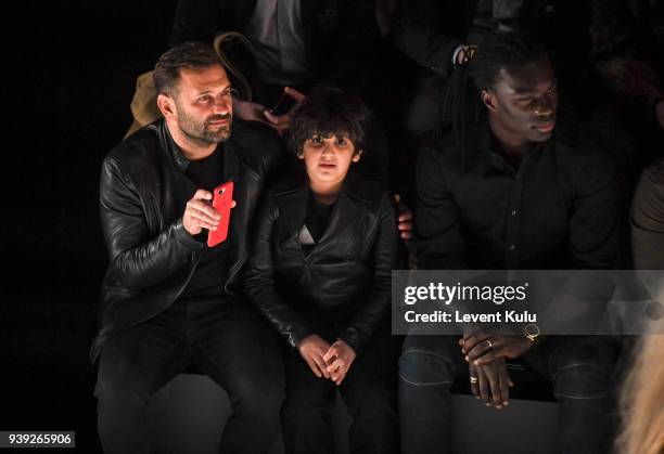 Okan Buruk with his son and Bafetimbi Gomis attend the St. Nian show during Mercedes Benz Fashion Week Istanbul at Zorlu Performance Hall on March...