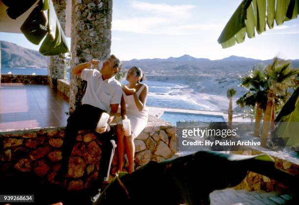 Actor and former baseball player Chuck Connors and actress fiance Kamala Devi sit outside at the Cabo San Lucas Hotel during a fishing trip circa...