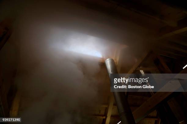 Steam from the evaporator rises up into the air as sap is boiled to make maple syrup inside The Gateway Farm in Bristol, VT on March 25, 2018. Trent...
