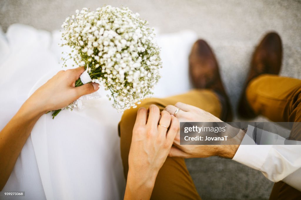 Bride and groom holding their hands together