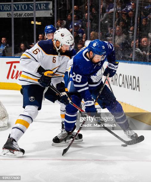 Connor Brown of the Toronto Maple Leafs skates against Marco Scandella of the Buffalo Sabres during the first period at the Air Canada Centre on...